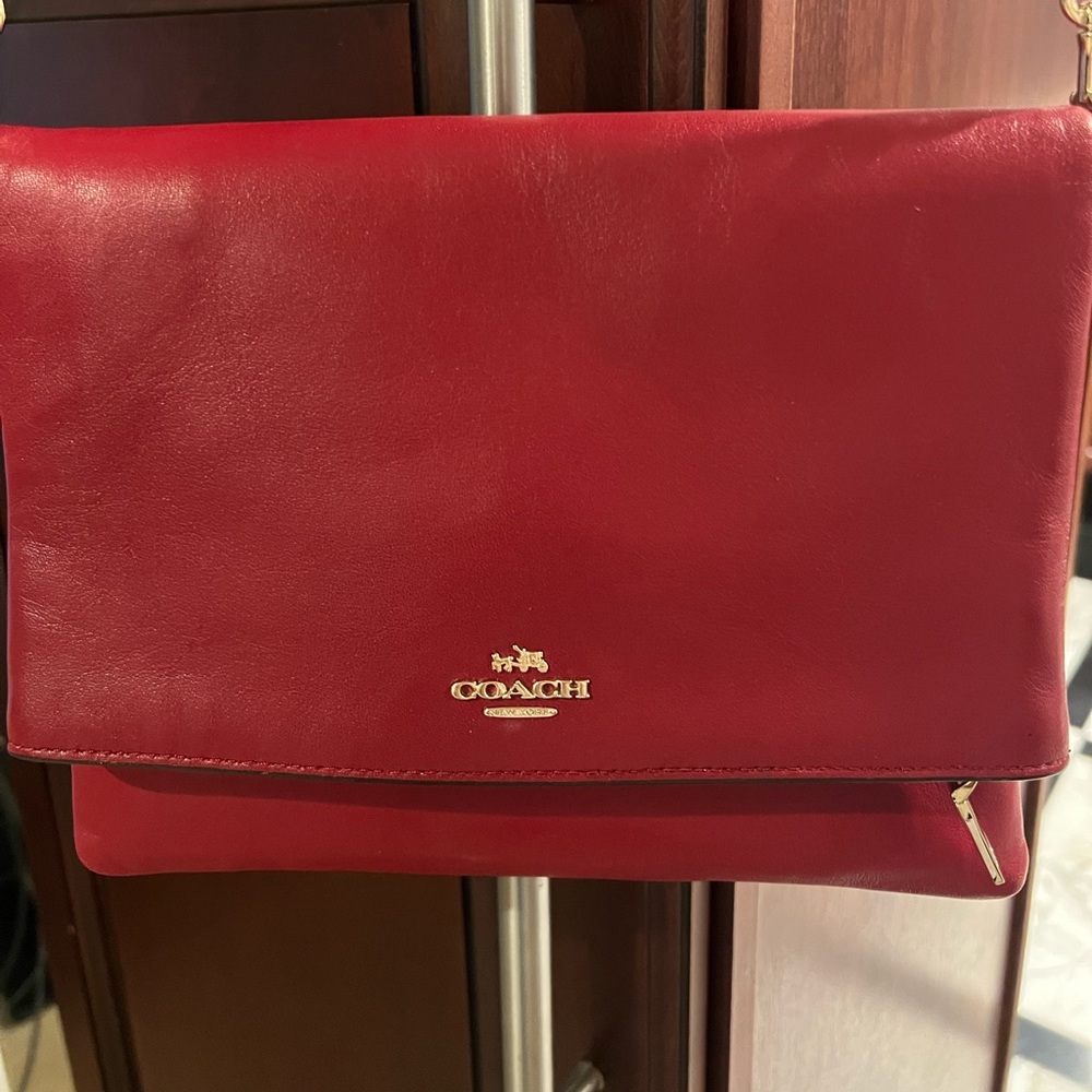 Authentic Coach fold over cross body bag
Red color, gently used.